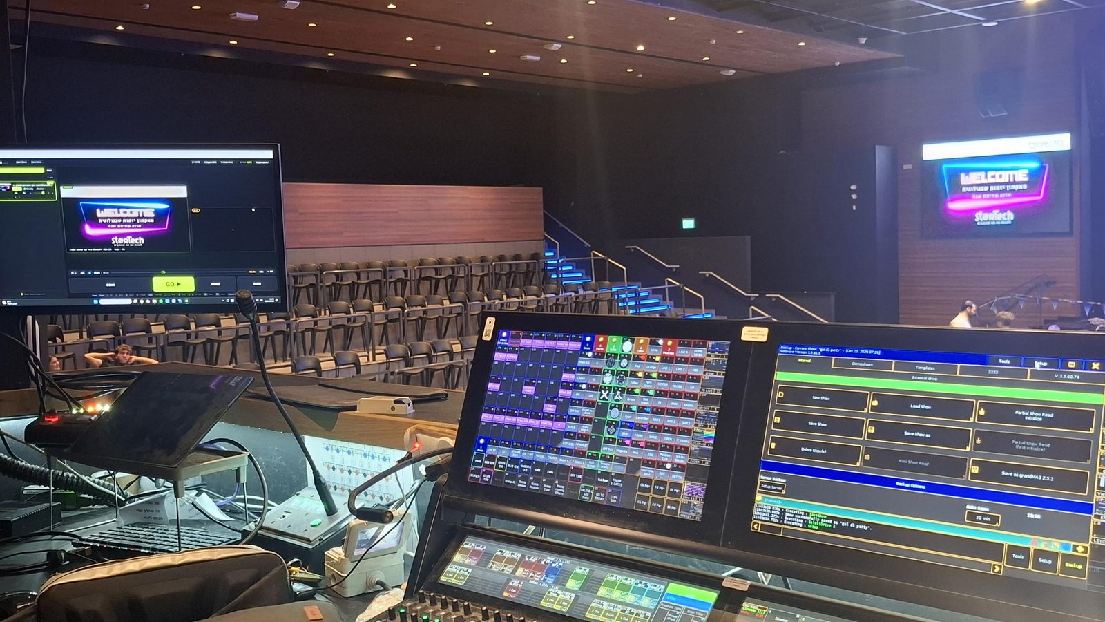 Cuey at the control position next to a lighting console
